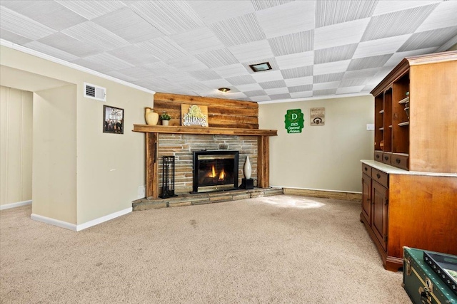 unfurnished living room with light carpet, visible vents, a stone fireplace, and baseboards