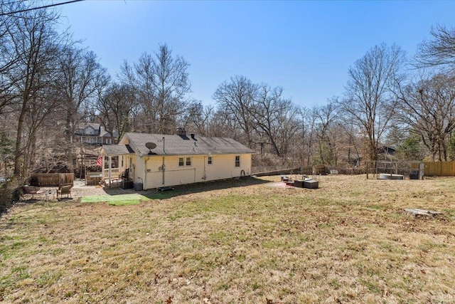 exterior space with a vegetable garden, a lawn, and fence