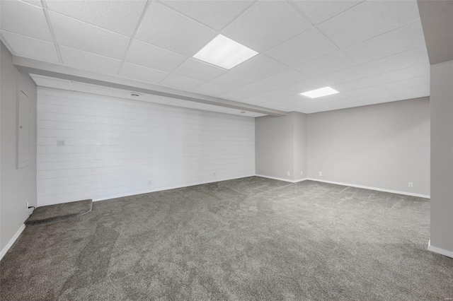 interior space with a paneled ceiling, baseboards, and carpet floors