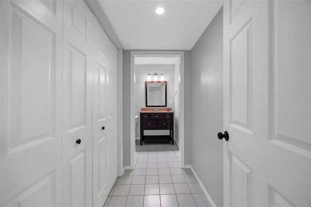 hall with light tile patterned floors and baseboards