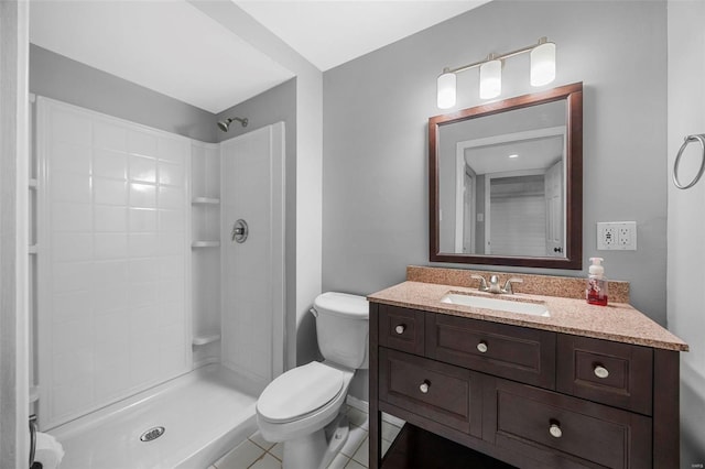 full bath with toilet, vanity, and a tile shower