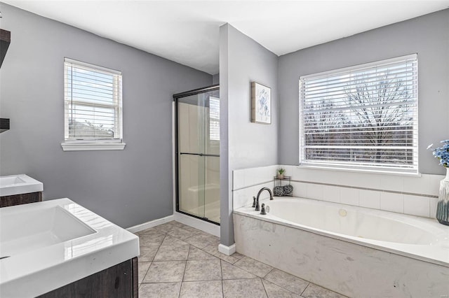 full bath with tile patterned flooring, a healthy amount of sunlight, a bath, and a shower stall