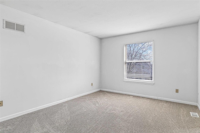 carpeted empty room with baseboards and visible vents