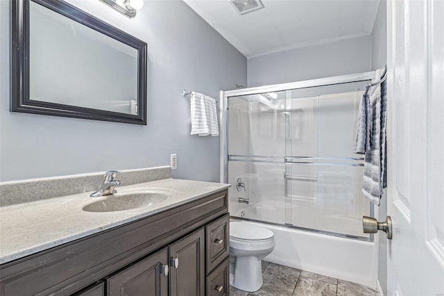 full bath featuring visible vents, toilet, vanity, and shower / bath combination with glass door