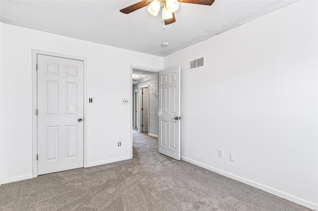 unfurnished bedroom with visible vents, baseboards, a ceiling fan, and carpet flooring