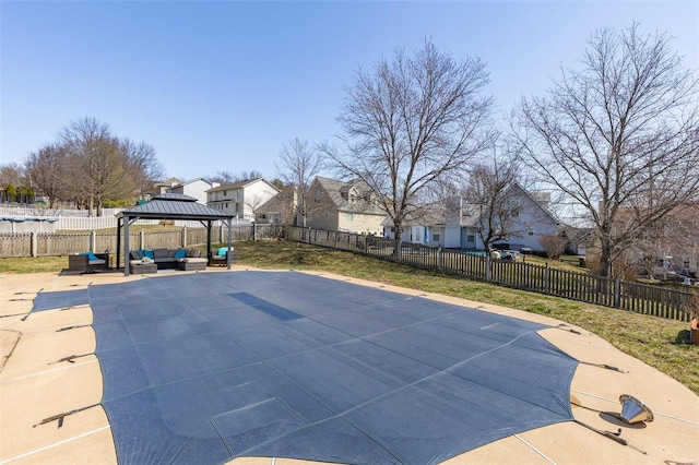 view of swimming pool featuring a patio area, a gazebo, a fenced backyard, and an outdoor hangout area