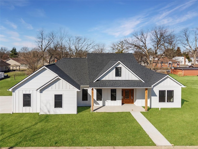 view of front facade featuring a front yard, a porch, board and batten siding, and roof with shingles