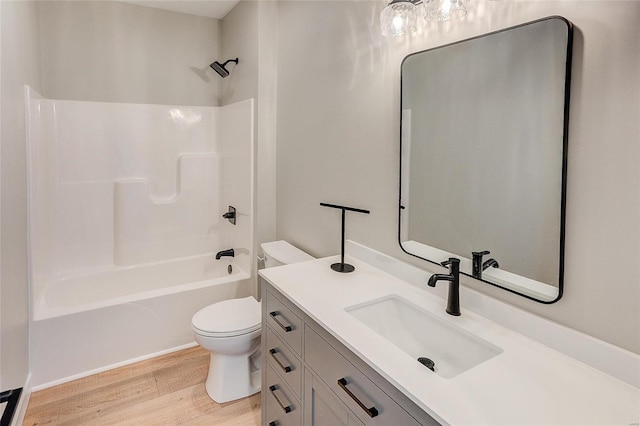 full bathroom with shower / bathtub combination, vanity, wood finished floors, and toilet