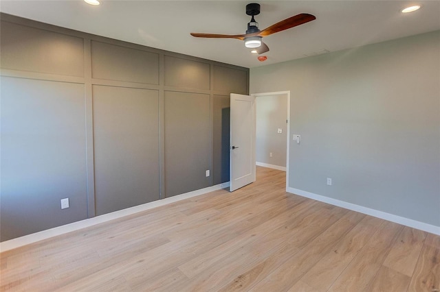 unfurnished bedroom with light wood-style floors, recessed lighting, a closet, and baseboards