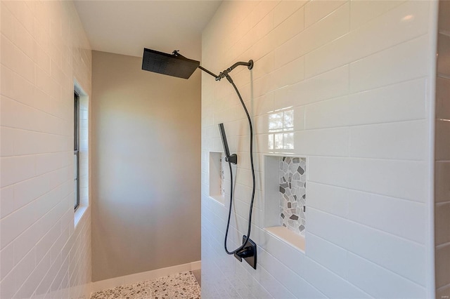 full bath featuring tiled shower