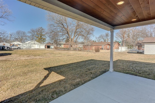 view of yard with a patio area, a residential view, and an outbuilding