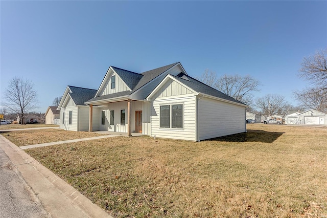 modern inspired farmhouse featuring board and batten siding and a front yard