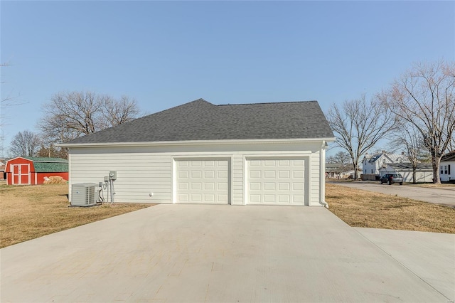 garage featuring a storage shed and cooling unit