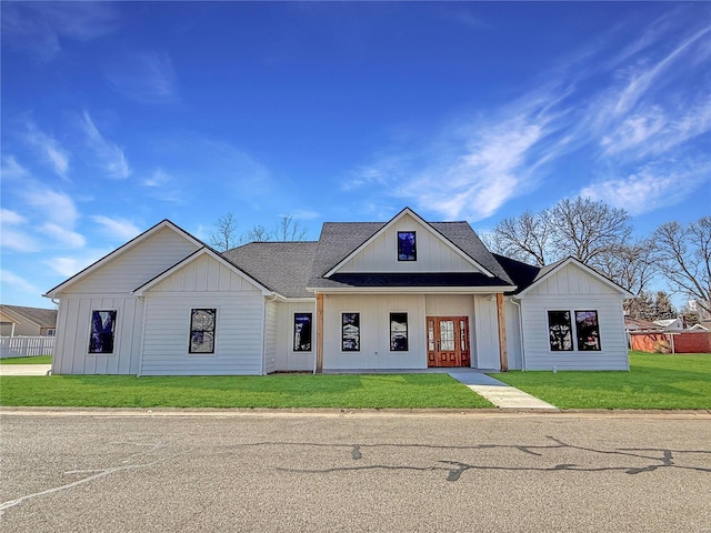 modern inspired farmhouse featuring a shingled roof, board and batten siding, and a front yard