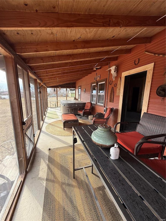 sunroom / solarium featuring lofted ceiling with beams and wood ceiling