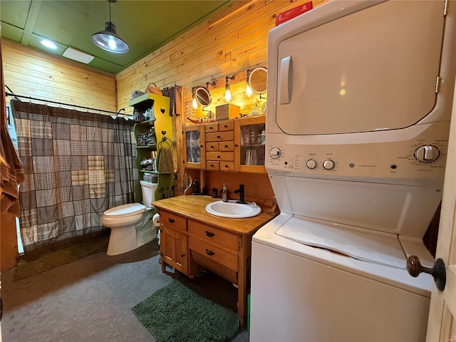 full bathroom with toilet, a shower with curtain, stacked washer / drying machine, and wood walls