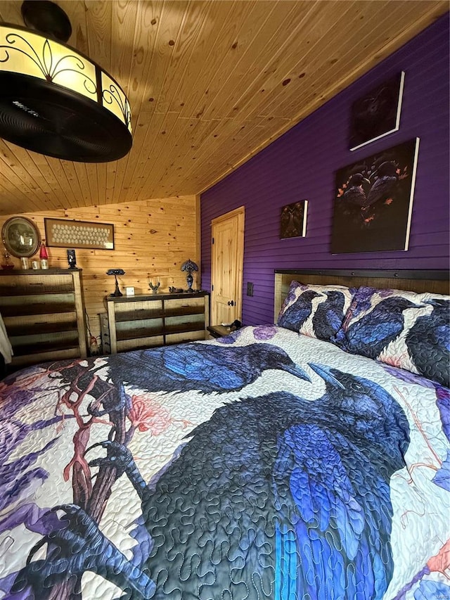 bedroom with wooden ceiling and wooden walls