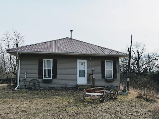 view of front of property with entry steps and metal roof