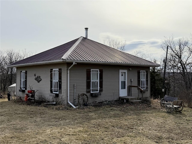 rear view of house with a standing seam roof and metal roof