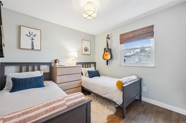 bedroom with wood finished floors and baseboards