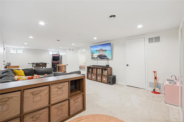 living room featuring recessed lighting, visible vents, and light carpet