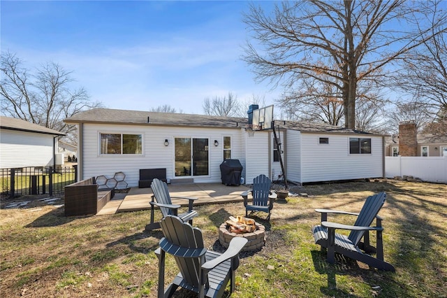 back of property with a patio, fence, an outdoor fire pit, a yard, and an outdoor structure