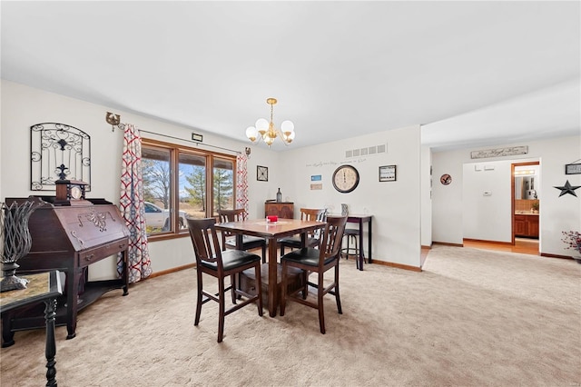 dining space with light carpet, visible vents, a chandelier, and baseboards