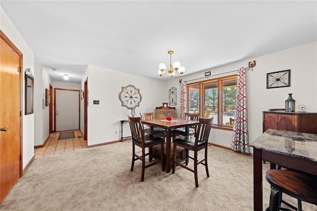 dining area with light tile patterned floors, baseboards, light colored carpet, and an inviting chandelier