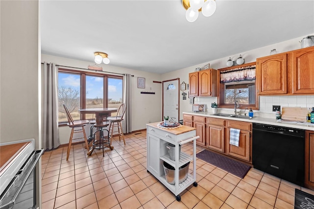 kitchen with a sink, stove, light countertops, black dishwasher, and tasteful backsplash