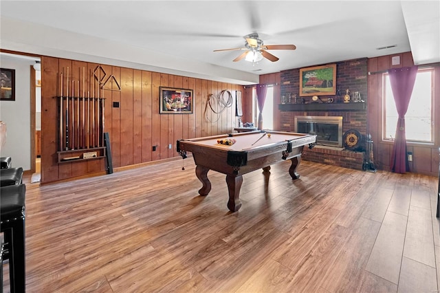 recreation room with billiards, a ceiling fan, visible vents, light wood finished floors, and a fireplace