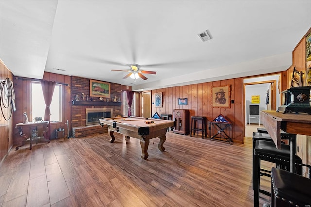 recreation room with visible vents, billiards, wood finished floors, and a fireplace