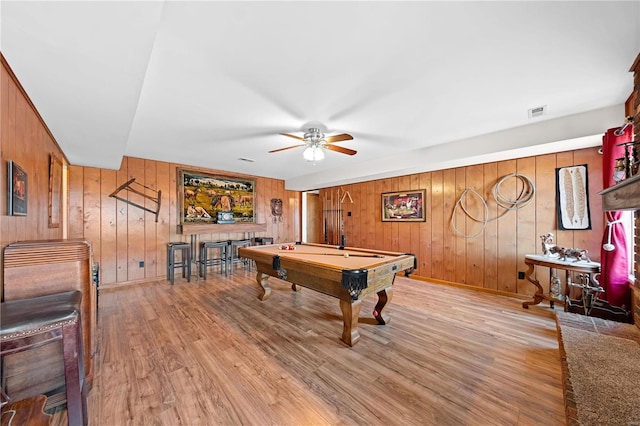 recreation room featuring light wood finished floors, baseboards, ceiling fan, a dry bar, and billiards