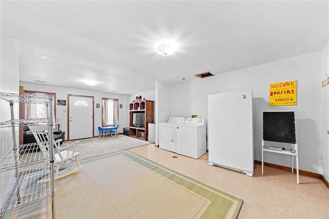 interior space with washer and clothes dryer, visible vents, and baseboards