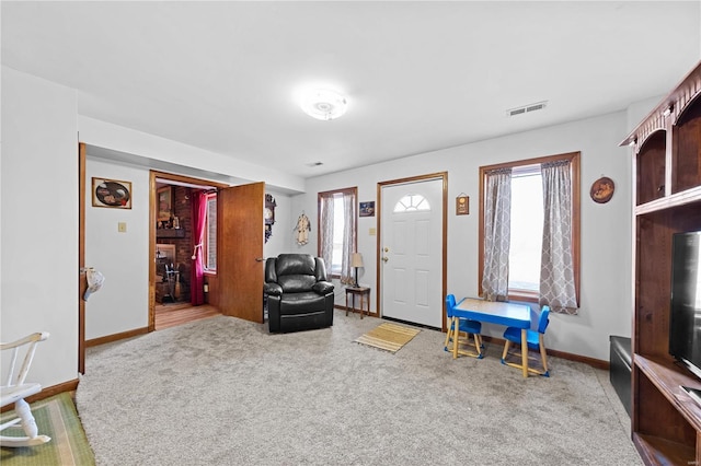 carpeted entrance foyer with visible vents and baseboards