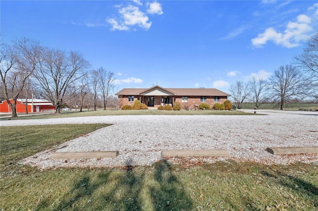 exterior space with a front yard and brick siding