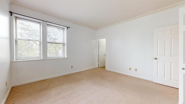 unfurnished room with crown molding, baseboards, and carpet floors