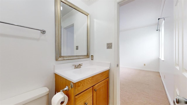 bathroom featuring vanity, toilet, and baseboards