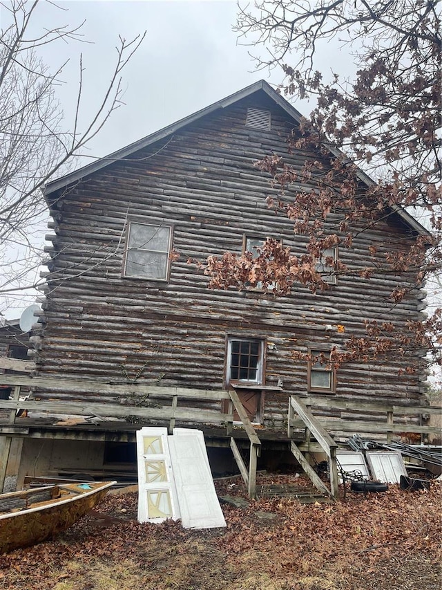 view of property exterior featuring log siding