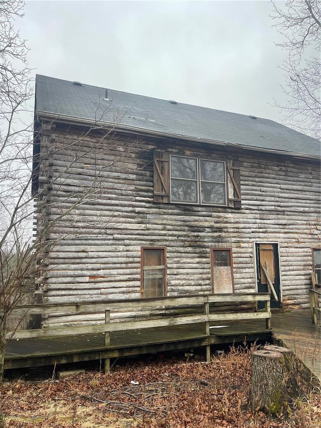 rear view of property featuring log siding