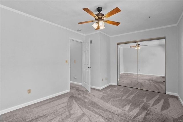 unfurnished bedroom with a ceiling fan, carpet flooring, crown molding, and baseboards