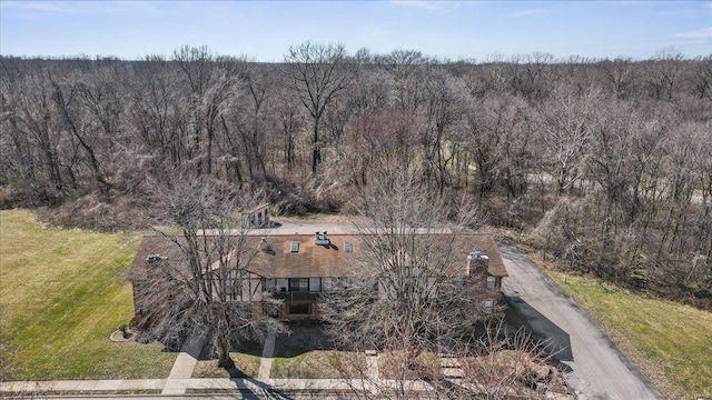 drone / aerial view featuring a forest view