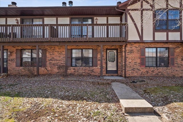 view of property with stucco siding and brick siding