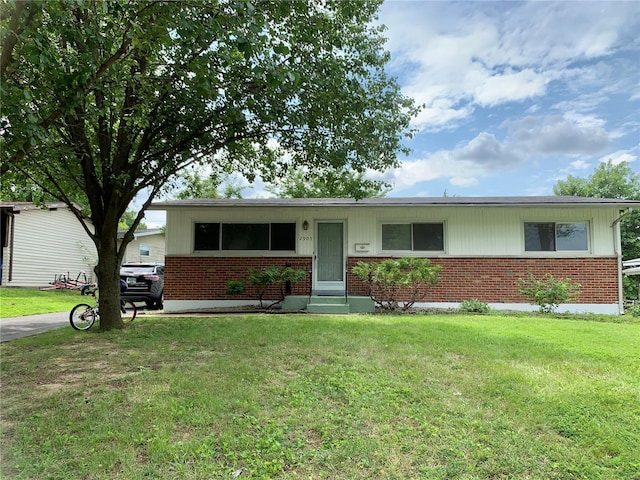 single story home with a front lawn and brick siding