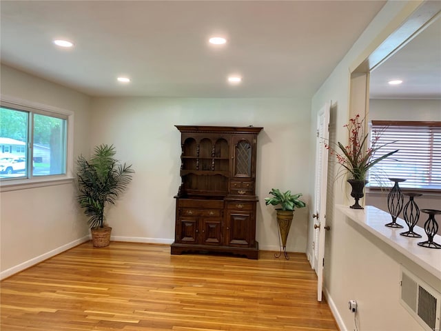 sitting room featuring baseboards, light wood finished floors, and recessed lighting