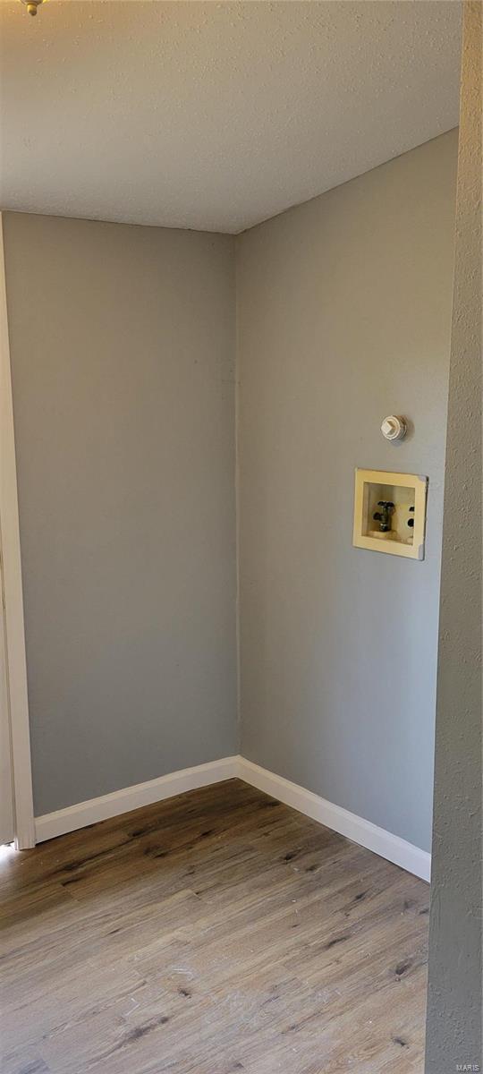 washroom with baseboards, wood finished floors, laundry area, and washer hookup