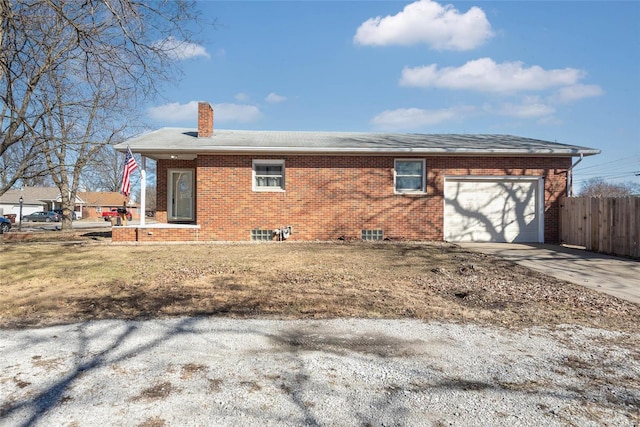 view of side of property featuring fence, concrete driveway, a garage, brick siding, and a chimney