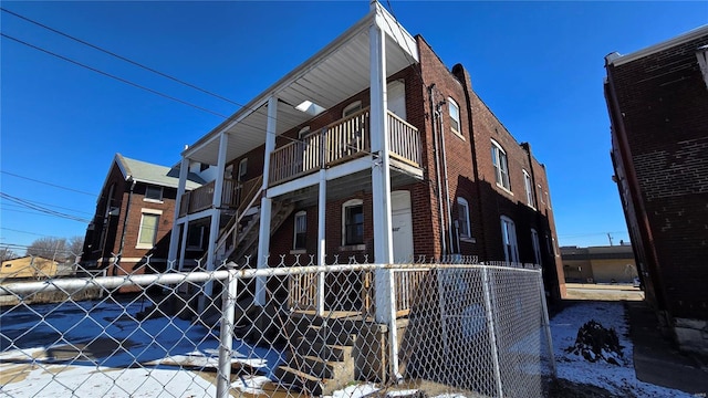 view of home's exterior featuring fence and brick siding