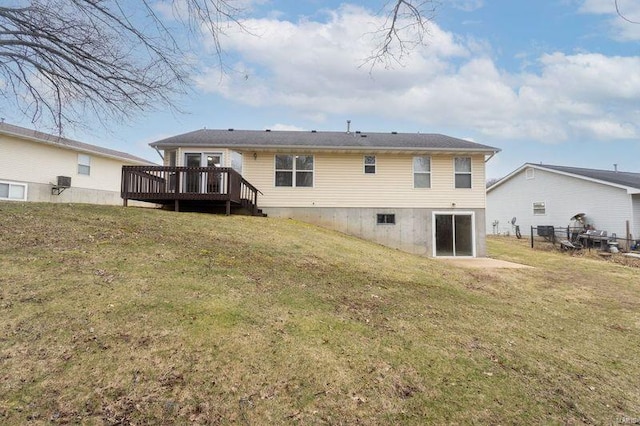 back of property featuring fence, a deck, and a yard