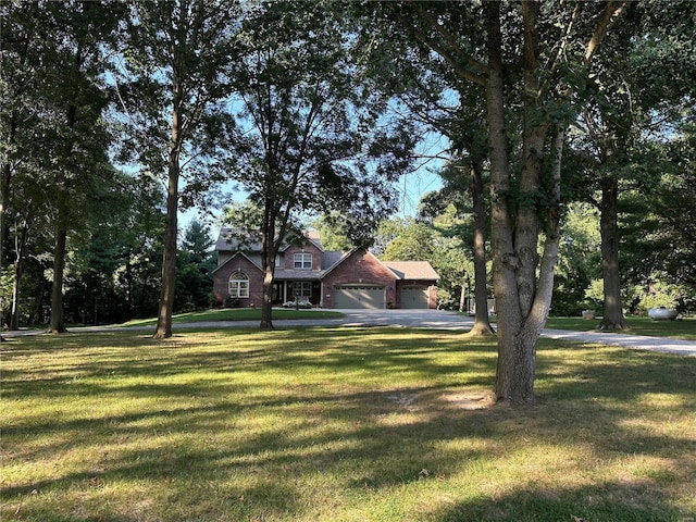 view of front of house with a garage and a front lawn