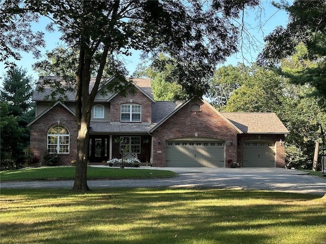 view of front of house with an attached garage, brick siding, driveway, roof with shingles, and a front lawn